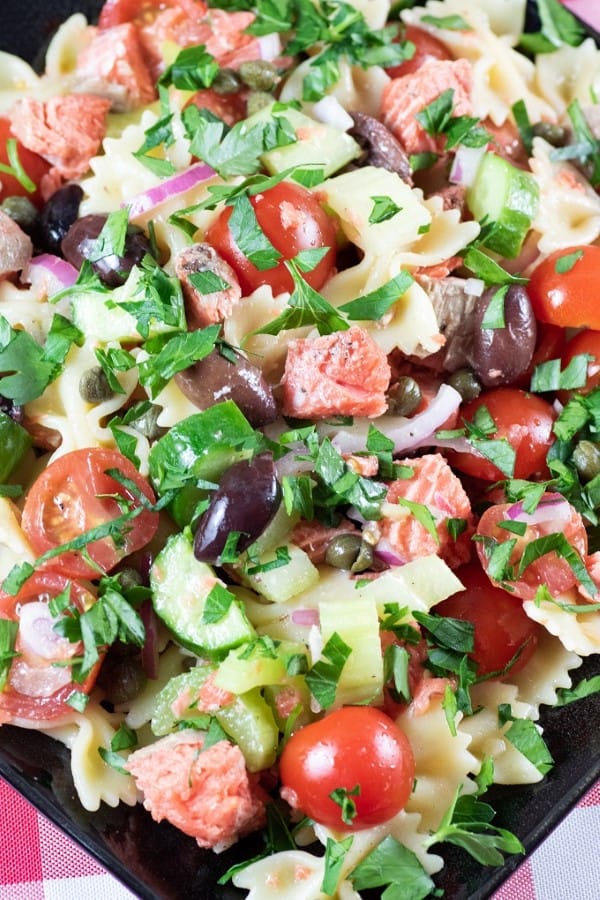 GRILLED SALMON PASTA SALAD on a black plate