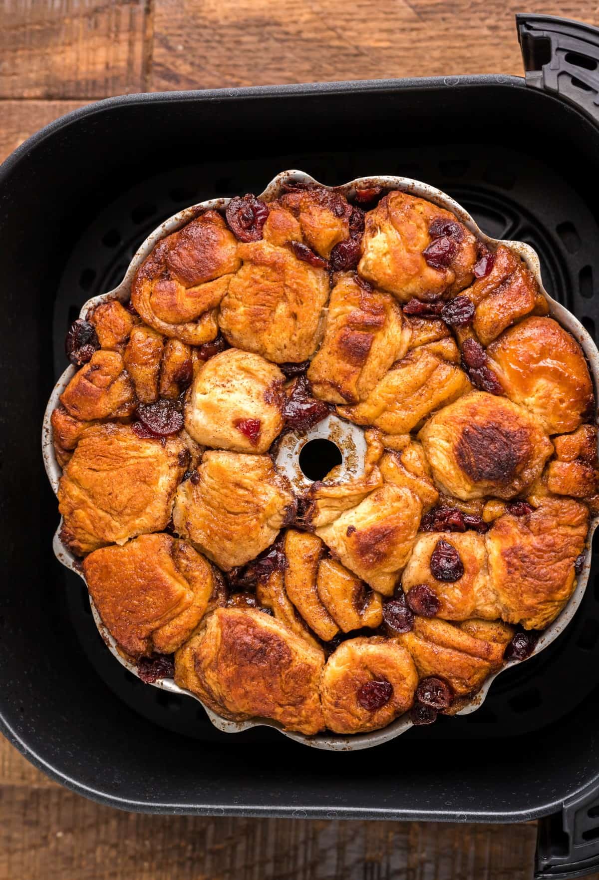 Air Fryer Holiday Monkey Bread is full of ooey-gooey caramel goodness, cinnamon and cranberries. The perfect easy holiday brunch dish. Overhead view of just baked monkey bread.