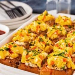 Bacon, Egg, and Cheese sliders in a white casserole dish.