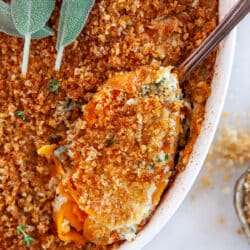 Sweet Potato Au Gratin, taking a scoop from a casserole.