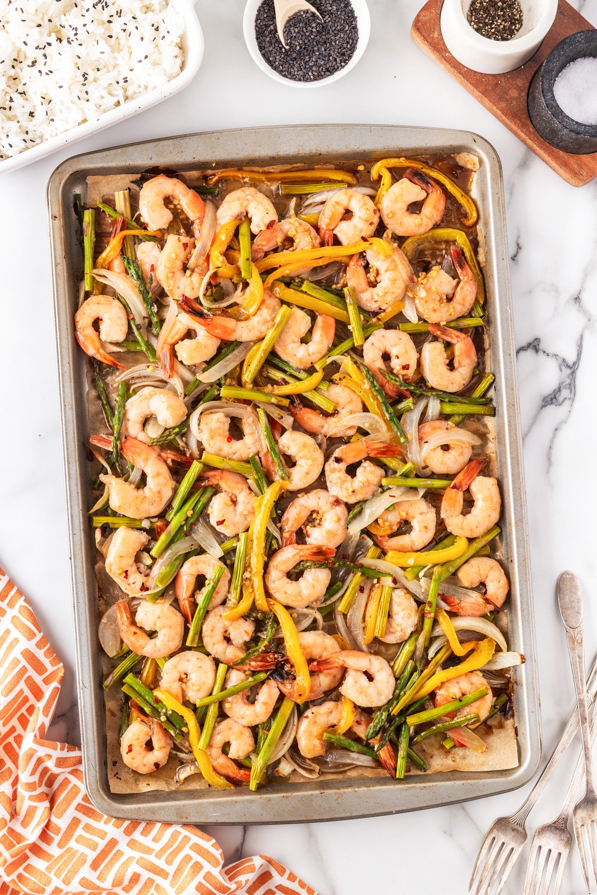 This awesome Shrimp Stir Fry Recipe - Easy Oven Method will have you grabbing the sheet pan again and again. The stir fry sauce with honey, garlic, ginger and more will be what you fall in love with. Sheet pan cooked shrimp and veggies.