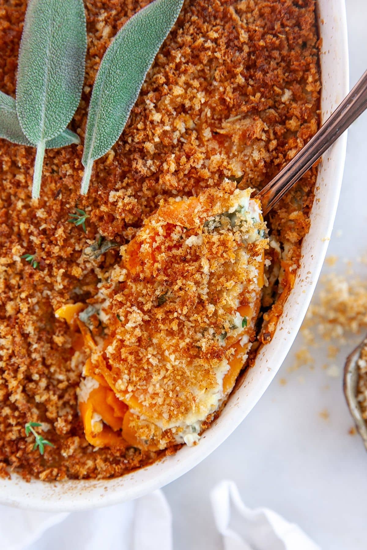 These 32 Amazing Thanksgiving/Holiday Sides will be your go to roundup for all your side dishes for family and friend celebrations for the season. Spoonful of sweet potato au gratin being removed from a casserole dish.