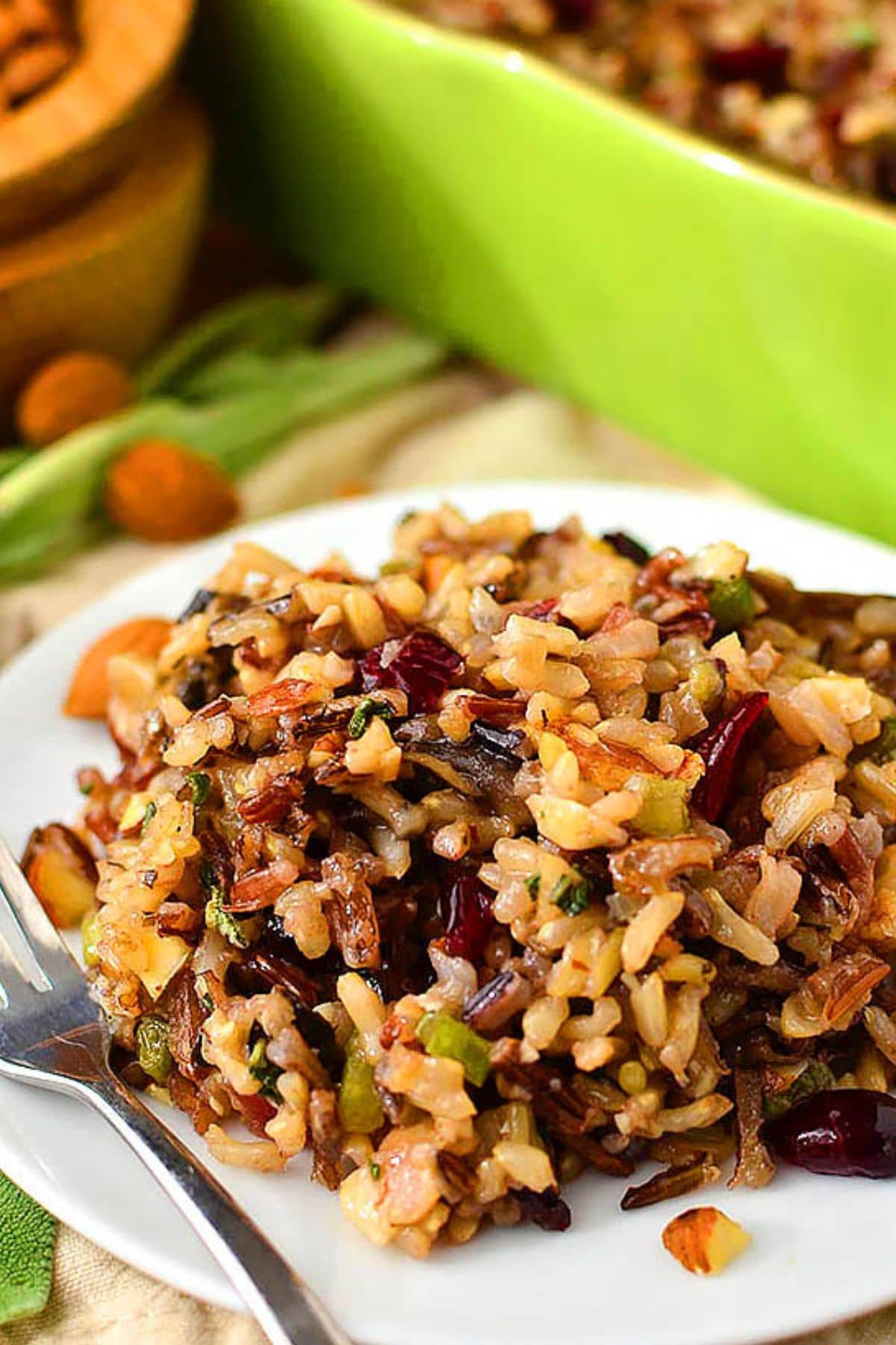 These 32 Amazing Thanksgiving/Holiday Sides will be your go to roundup for all your side dishes for family and friend celebrations for the season. Plate full of wild rice stuffing alongside a fork.