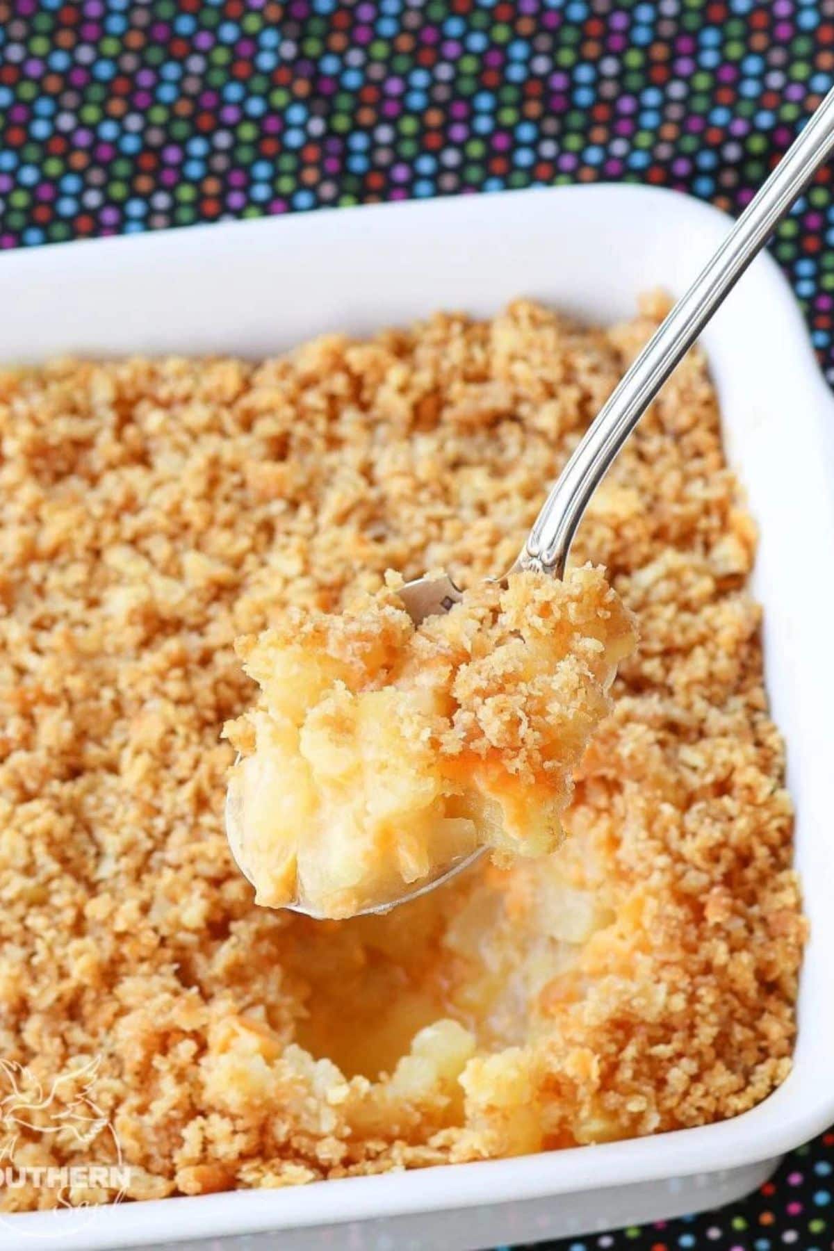 This 25 New Holiday Casserole Roundup will help you finish off all your holiday menus with a delicious side dish or main. So many to choose from you will want to try more than one. Spoonful of pineapple casserole held above a full casserole dish.
